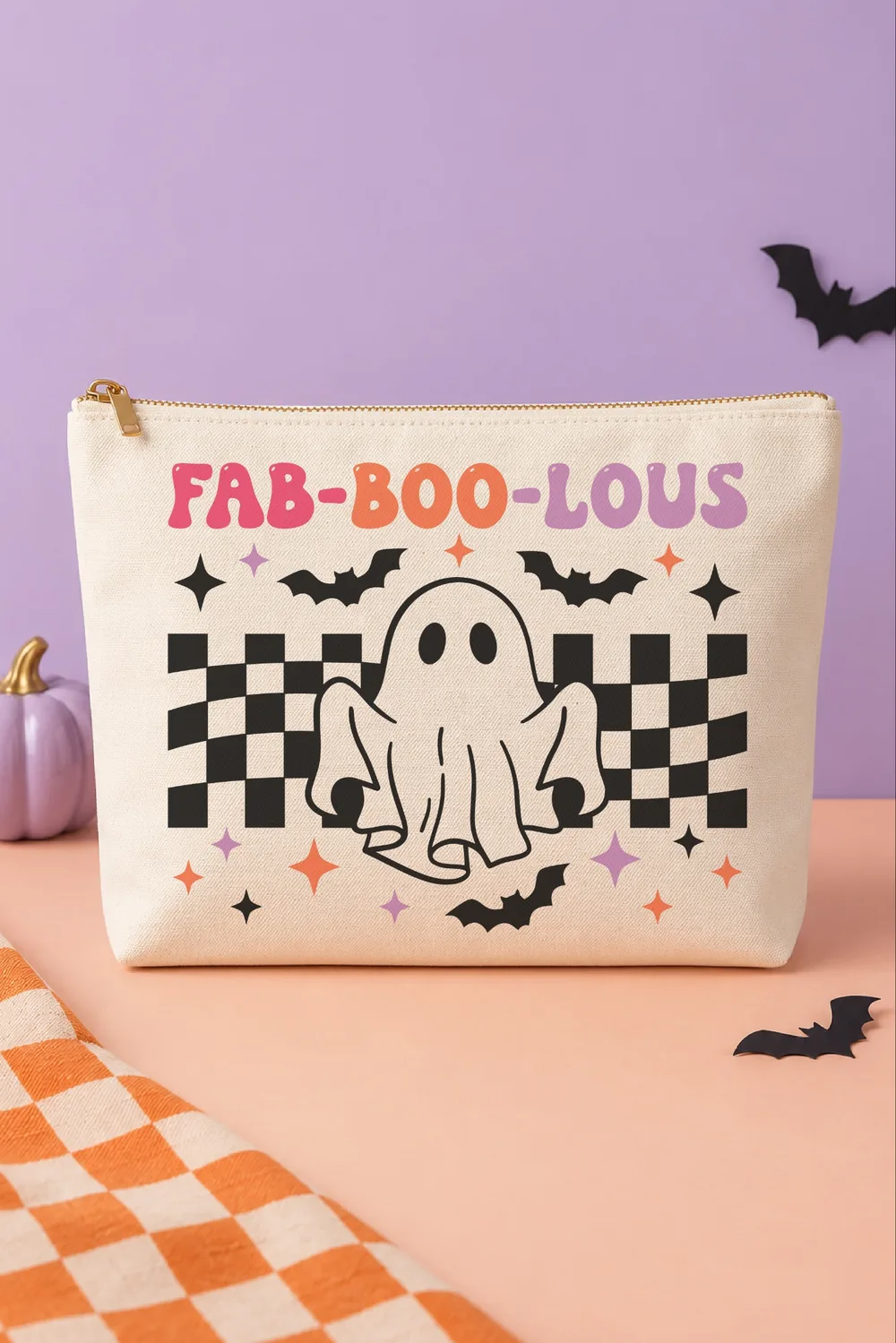 Cream canvas zippered bag on a peach table with a retro ghost, checkerboard, bats and pink, orange, purple Fab-Boo-Lous text