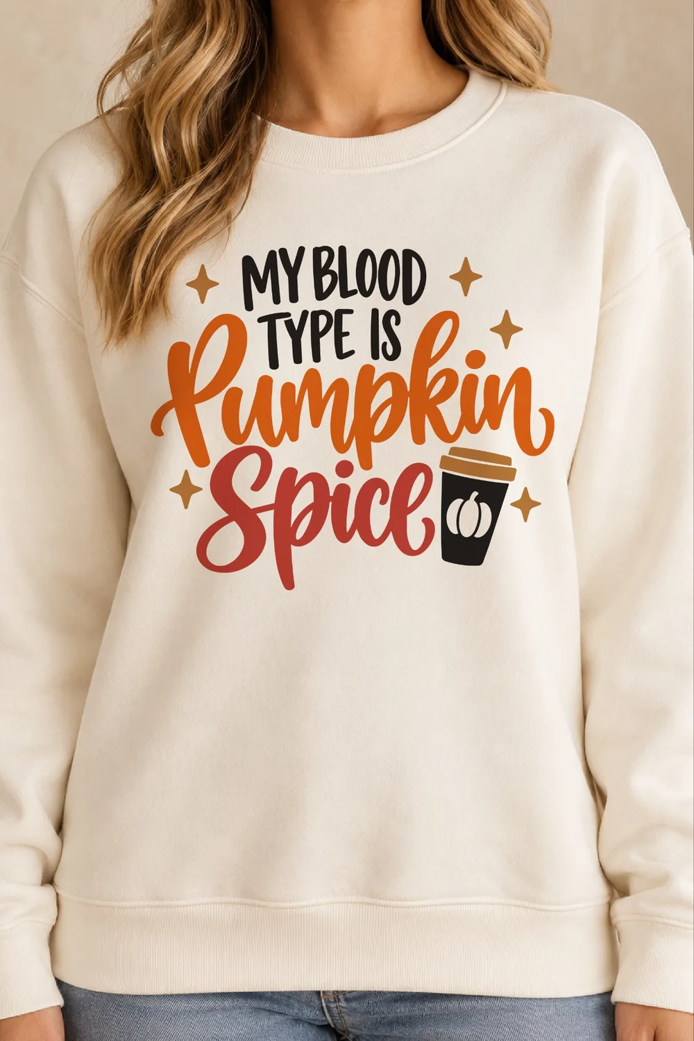 Cream crewneck sweatshirt with My Blood Type Is Pumpkin Spice in black, orange and red, a coffee cup and sparkles