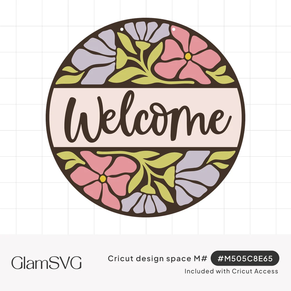 Round welcome sign with script lettering on a pale band, surrounded by pink and lavender flowers and green leaves